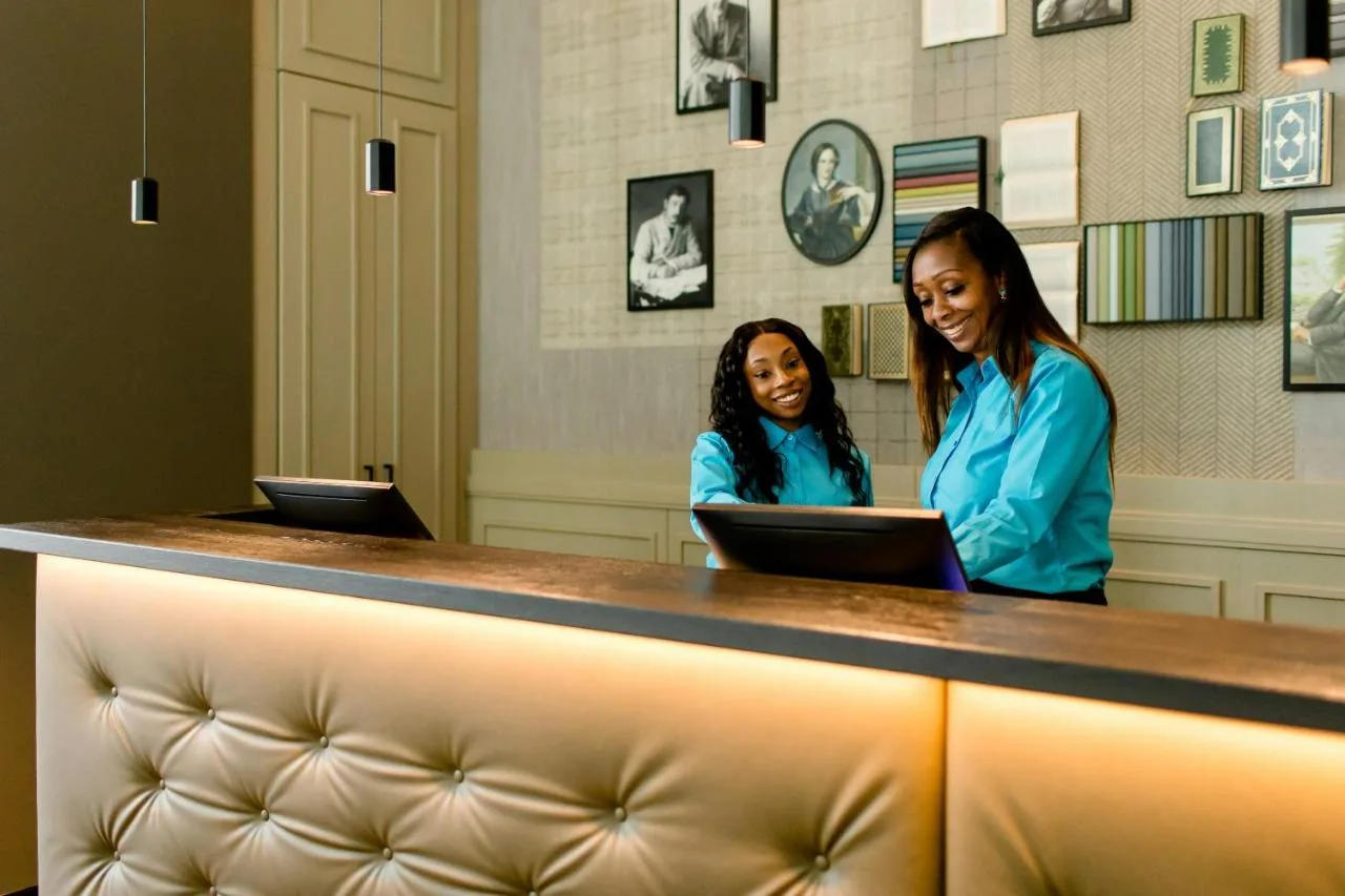 Guests working on laptops in the hotel lounge